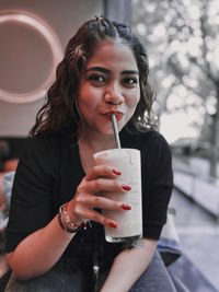 Portrait of young woman using mobile phone