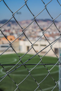 Close-up of chainlink fence against sky