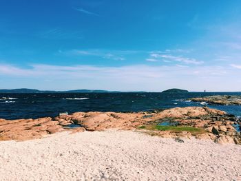 Scenic view of beach against blue sky