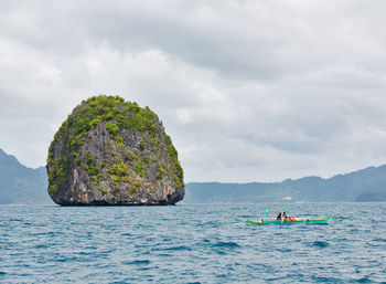 Scenic view of rocks in sea against sky
