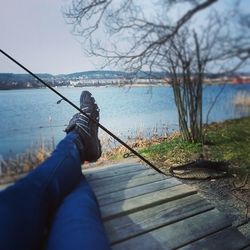 Rear view of people relaxing on lakeshore