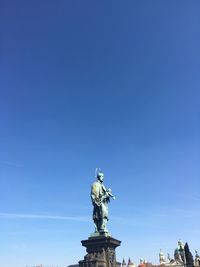 Low angle view of statue against blue sky