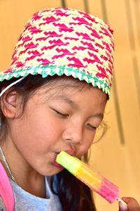 Close-up of cute girl eating ice lolly