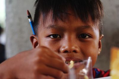 Close-up portrait of boy drinking drink