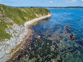 High angle view of rocks on beach against sky