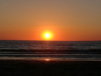 Scenic view of sea against clear sky during sunset