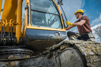 Side view of man working at construction site