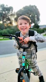 Young boy on bmx bike smiling at camera