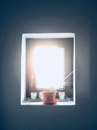 Close-up of illuminated tea light on table at home