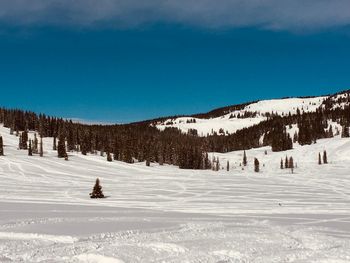 Scenic view of snow covered mountains against sky