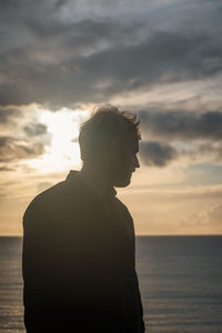 Man looking at sea against sky