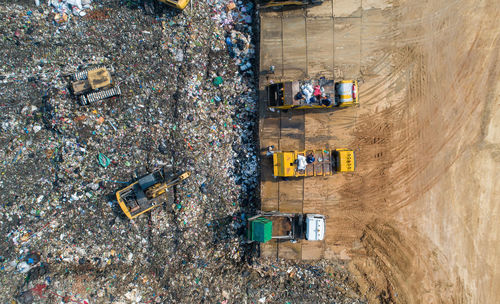 A lot of waste is disposed of in the waste disposal pits. loaders is working on a mountain garbage.