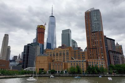 View of skyscrapers against cloudy sky