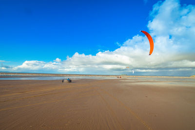 Scenic view of beach against blue sky