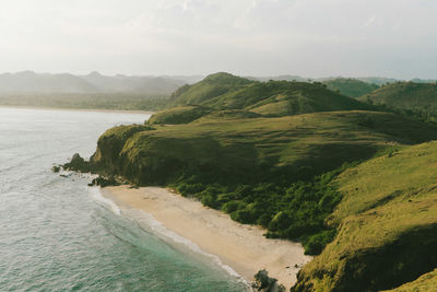 Scenic view of sea and mountains against sky