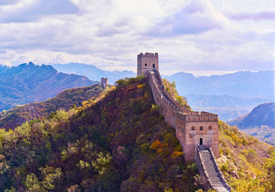 View of castle on mountain against cloudy sky