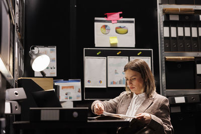 Young woman using mobile phone in office