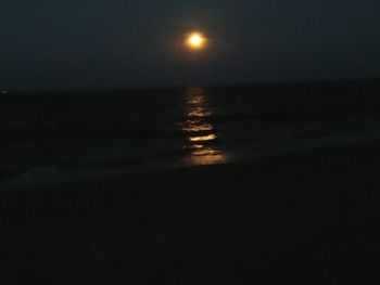 Scenic view of sea against sky at night