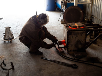 High angle view of man working on machine