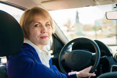 Portrait of woman sitting in car