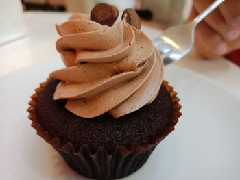 Close-up of hand holding cake