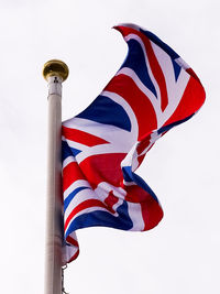 Low angle view of flag against clear sky