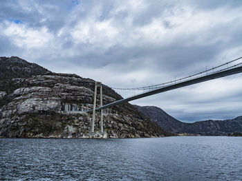 Low angle view of bridge over mountain against sky