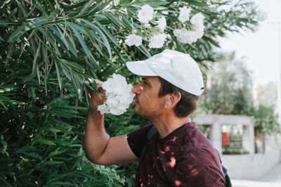 Mature real candid man traveler enjoys flowers on everyday moment. positive masculinity