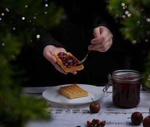 Cropped hand of woman having food