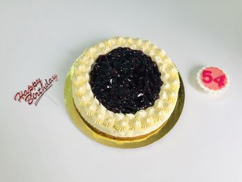 High angle view of cake on table against white background