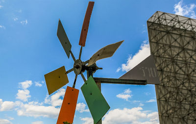 Low angle view of traditional windmill against sky