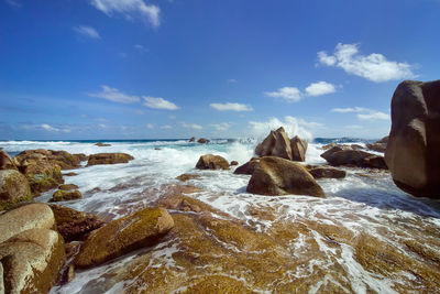 Rocks on beach against sky