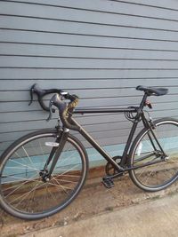 Bicycle parked against wall