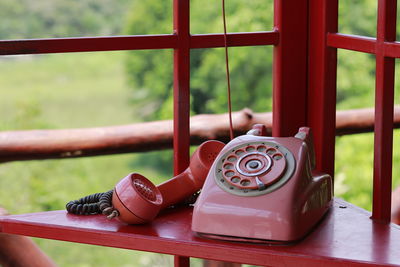 Close-up of telephone booth on table
