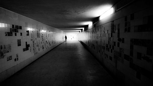 Woman walking in tunnel