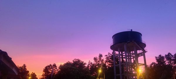 Low angle view of built structure against clear sky during sunset