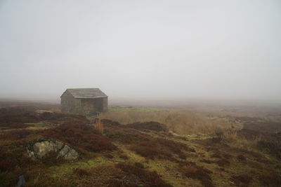 Built structure on field against sky