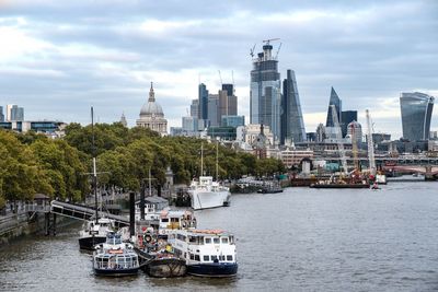 Boats in river with buildings in background