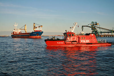 Fishing boat on sea against sky