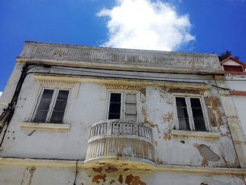 Low angle view of abandoned building against sky