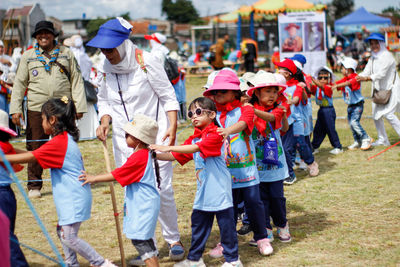 Group of people walking on field