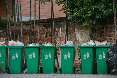 Garbage bin against wall in row