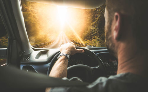 Rear view of man driving car