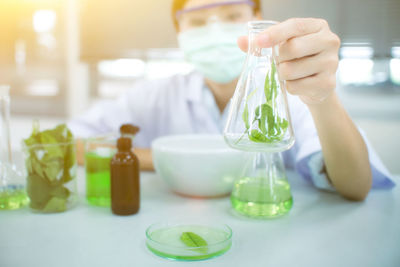 Portrait of woman experimenting chemical in laboratory