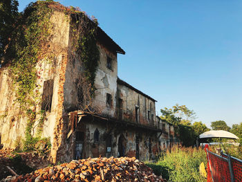 Low angle view of old building against clear blue sky