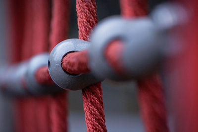 Close-up of metal chain hanging on rope