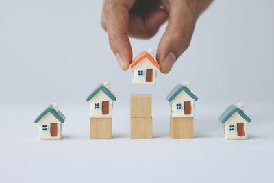 Cropped hand with toy blocks against white background