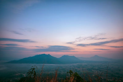 Scenic view of mountains against sky at sunset