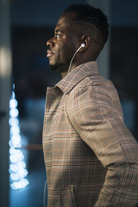 Side view of young man looking away