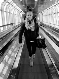 Full length of young woman at railroad station